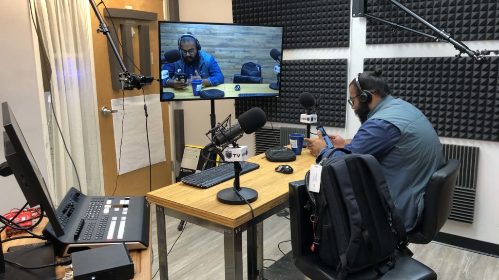 Angad Singh sits ready to film the Ask Drone U podcast inside of headquarters